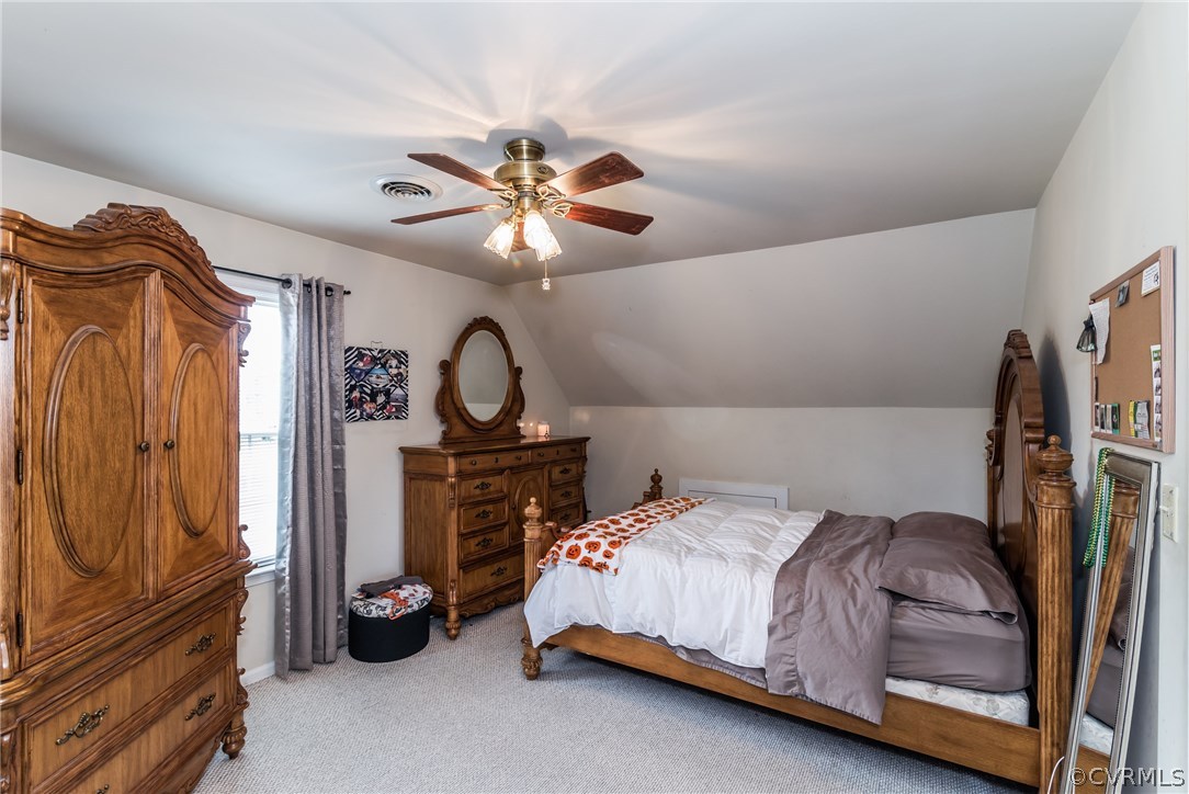 17445 Loving Union Road Disputanta, VA 23842 - Photo 33 of 50 a bedroom with a bed and a chandelier