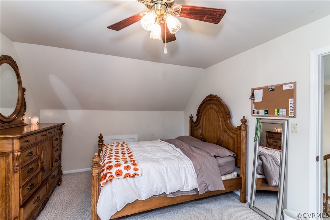17445 Loving Union Road Disputanta, VA 23842 - Photo 34 of 50 a bedroom with a bed and a chandelier