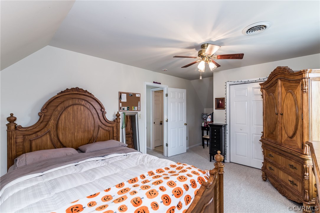 17445 Loving Union Road Disputanta, VA 23842 - Photo 35 of 50 a bedroom with a bed and a chandelier