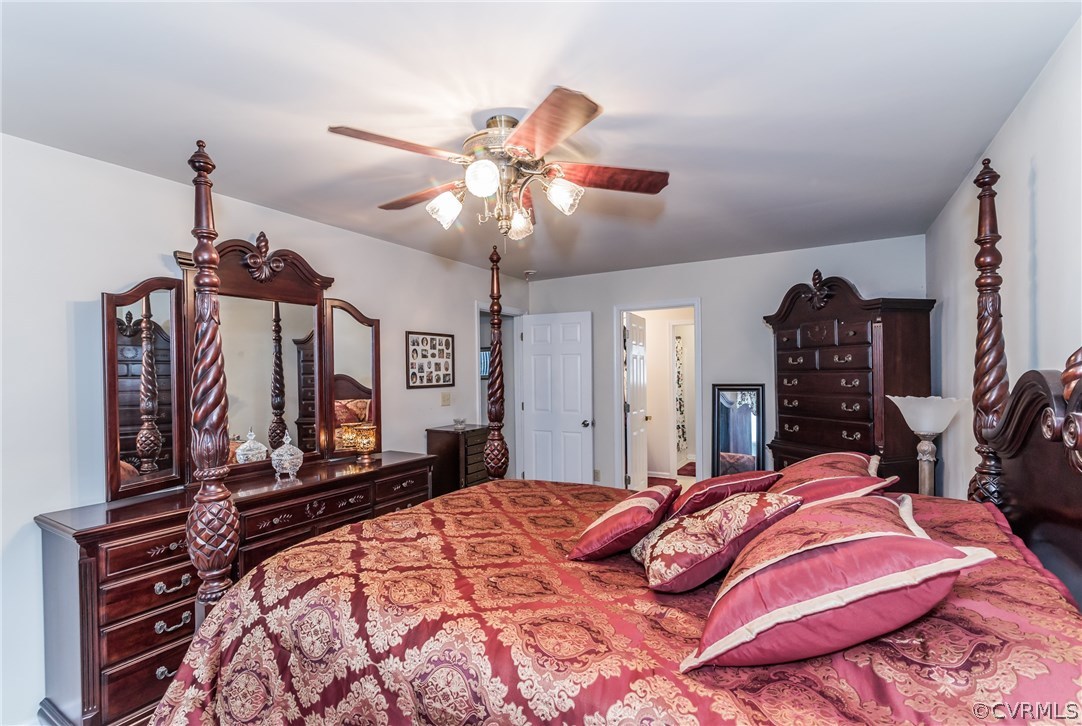 17445 Loving Union Road Disputanta, VA 23842 - Photo 4 of 50 a bedroom with a bed and a chandelier
