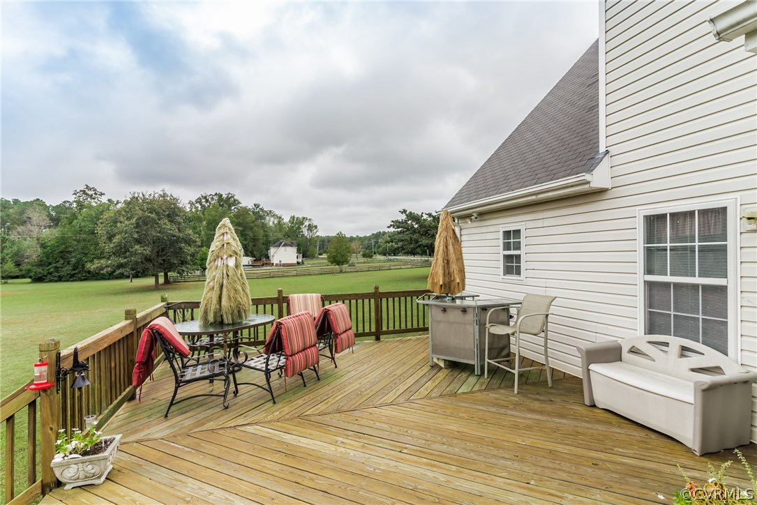 17445 Loving Union Road Disputanta, VA 23842 - Photo 46 of 50 a view of a roof deck with table and chairs a barbeque with wooden floor and fence