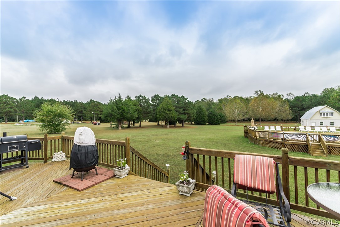 17445 Loving Union Road Disputanta, VA 23842 - Photo 48 of 50 a view of a deck with chairs next to a yard