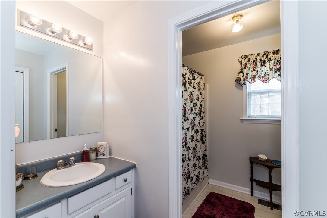 17445 Loving Union Road Disputanta, VA 23842 - Photo 7 of 50 a bathroom with a sink vanity and a mirror