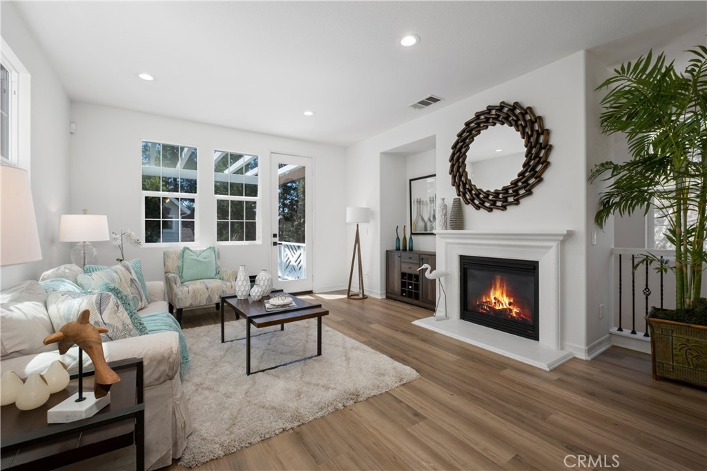 27 Reese Creek Ladera Ranch, CA 92694 - Photo 12 of 40 a living room with furniture a fireplace with wooden floor