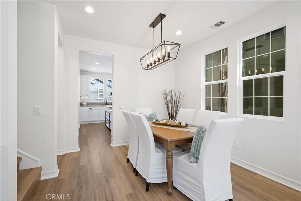 27 Reese Creek Ladera Ranch, CA 92694 - Photo 14 of 40 a view of a dining room with furniture wooden floor and chandelier
