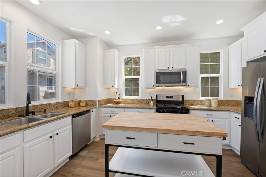 27 Reese Creek Ladera Ranch, CA 92694 - Photo 20 of 40 a kitchen with a stove a sink and a refrigerator