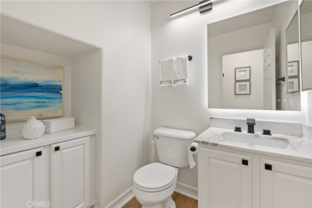 27 Reese Creek Ladera Ranch, CA 92694 - Photo 23 of 40 a bathroom with a granite countertop toilet sink and mirror
