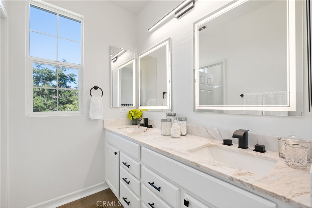27 Reese Creek Ladera Ranch, CA 92694 - Photo 27 of 40 a bathroom with a granite countertop sink and a mirror