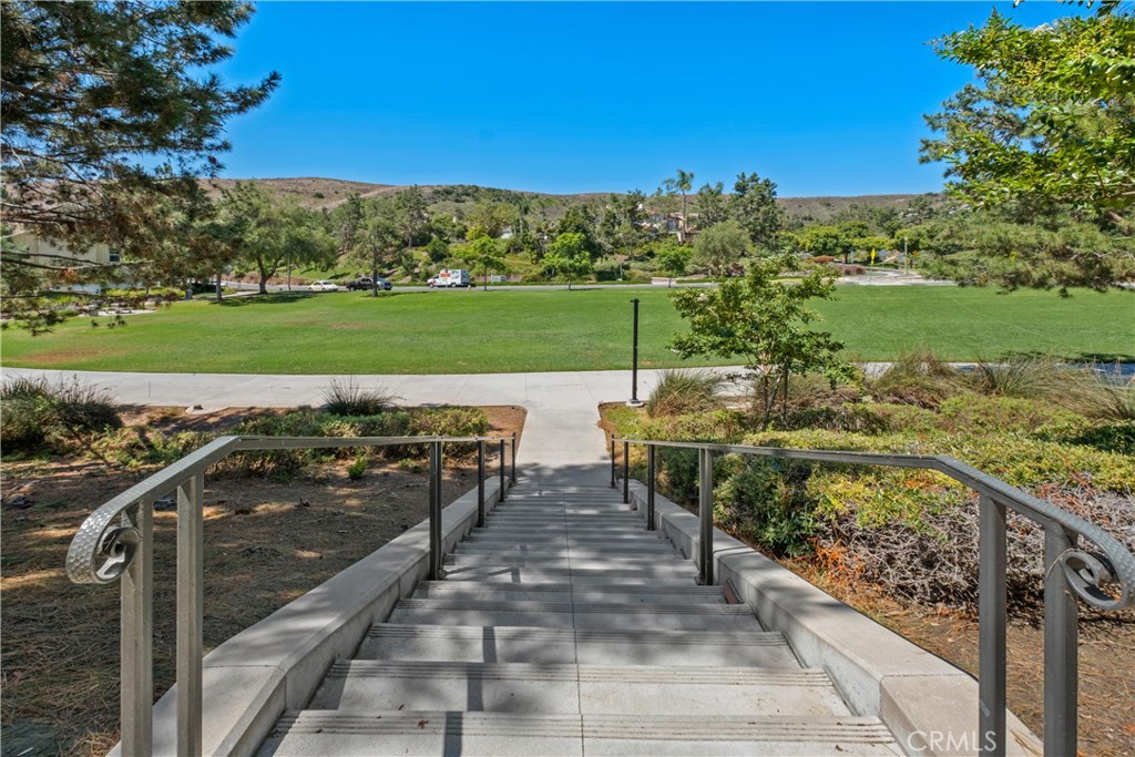 27 Reese Creek Ladera Ranch, CA 92694 - Photo 35 of 40 a view of a patio with lawn chairs floor to ceiling window and a yard