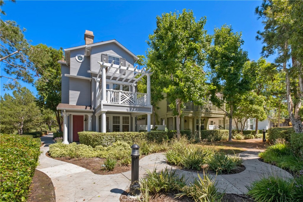 27 Reese Creek Ladera Ranch, CA 92694 - Photo 4 of 40 a front view of a residential apartment building with a yard