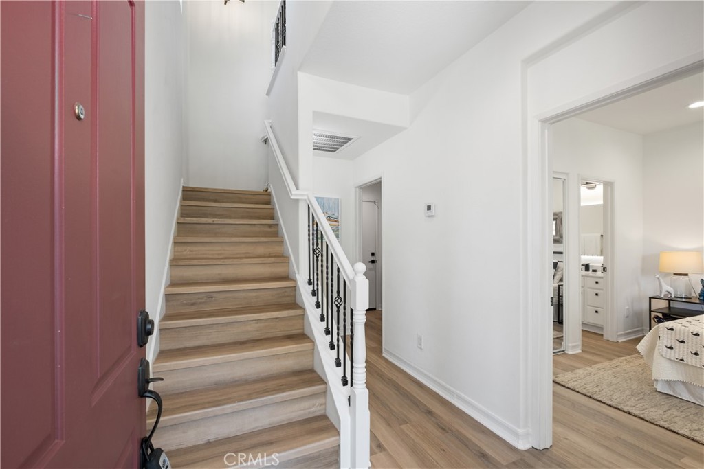 27 Reese Creek Ladera Ranch, CA 92694 - Photo 6 of 40 a view of a hallway with wooden floor and entryway