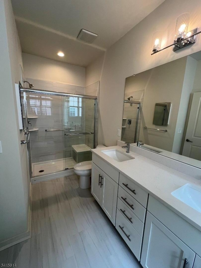 53 Norton Road Hillsborough, NJ 08844 - Photo 11 of 12 a spacious bathroom with a double vanity sink a toilet and a shower