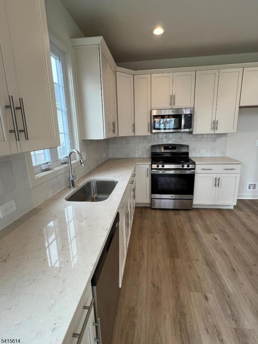 53 Norton Road Hillsborough, NJ 08844 - Photo 6 of 12 a kitchen with granite countertop a sink a counter top space appliances and cabinets