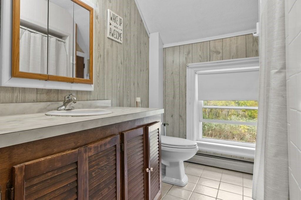 134 Bay State Road Rehoboth, MA 02769 - Photo 13 of 42 a bathroom with a granite countertop sink a toilet and a window
