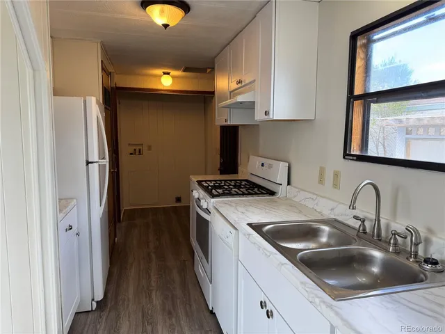 a kitchen with stainless steel appliances granite countertop a sink and wooden cabinets