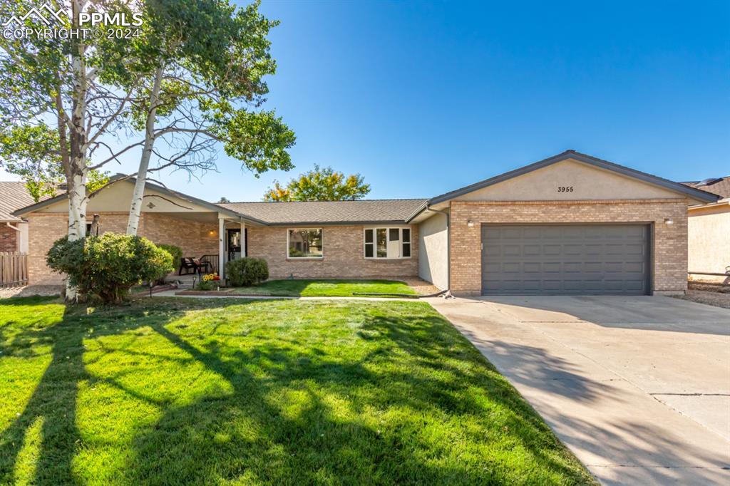 3955 Saddle Rock Road Colorado Springs, CO 80918 - Photo 1 of 45 a front view of a house with a yard and garage