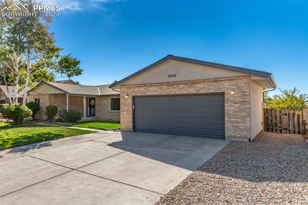 3955 Saddle Rock Road Colorado Springs, CO 80918 - Photo 2 of 45 a front view of a house with a yard and garage