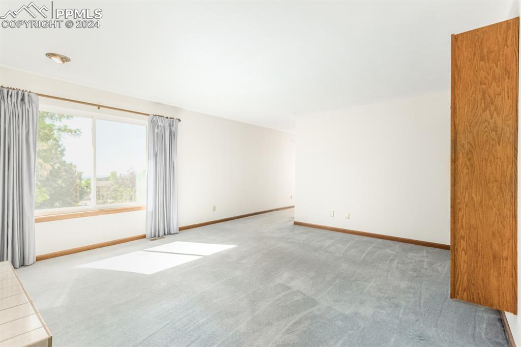 3955 Saddle Rock Road Colorado Springs, CO 80918 - Photo 21 of 45 a view of an empty room with a window