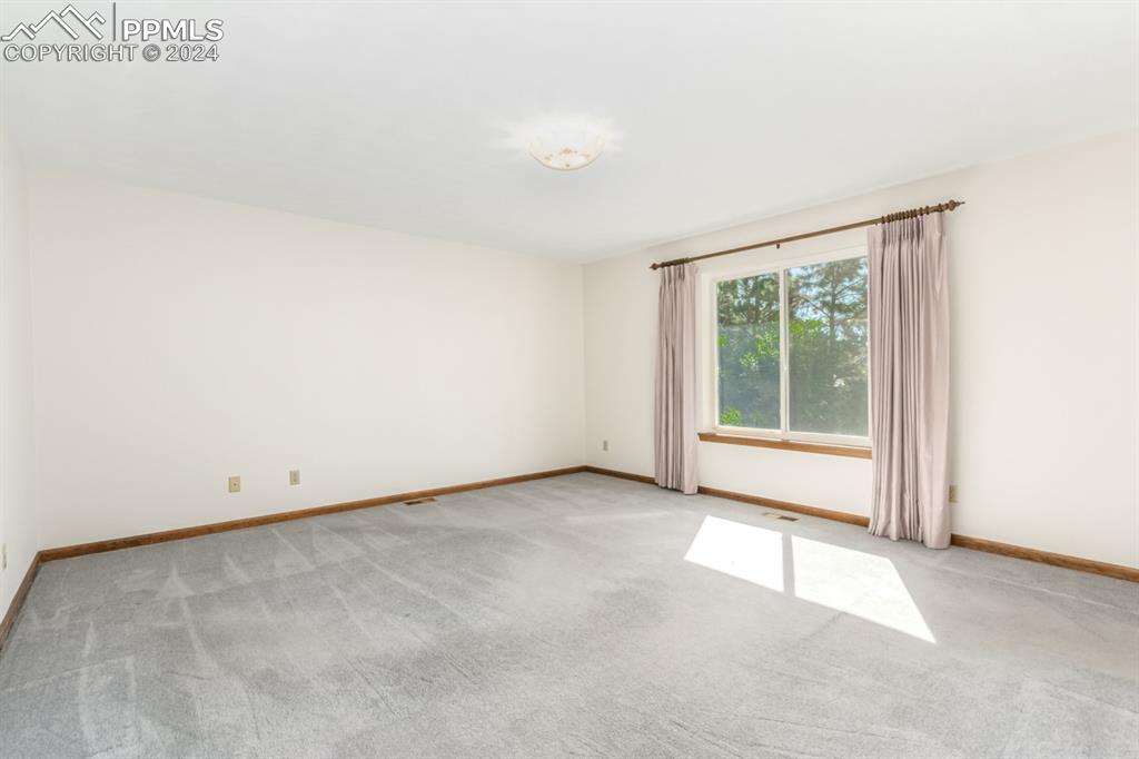 3955 Saddle Rock Road Colorado Springs, CO 80918 - Photo 22 of 45 an empty room with windows