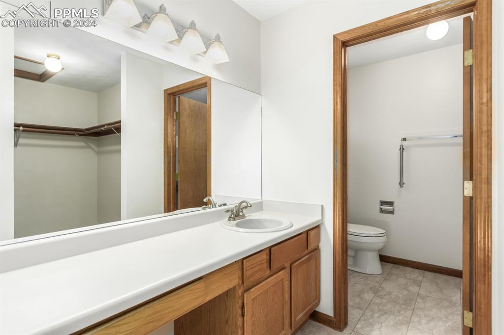 3955 Saddle Rock Road Colorado Springs, CO 80918 - Photo 24 of 45 a bathroom with a sink a toilet and shower