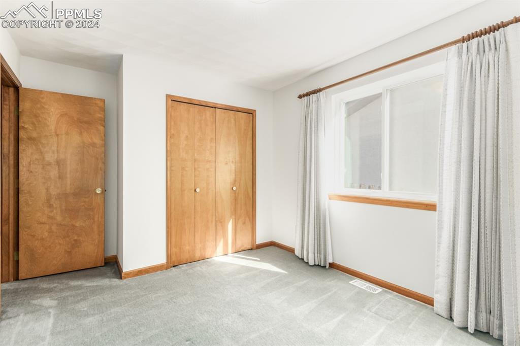 3955 Saddle Rock Road Colorado Springs, CO 80918 - Photo 28 of 45 an empty room with windows