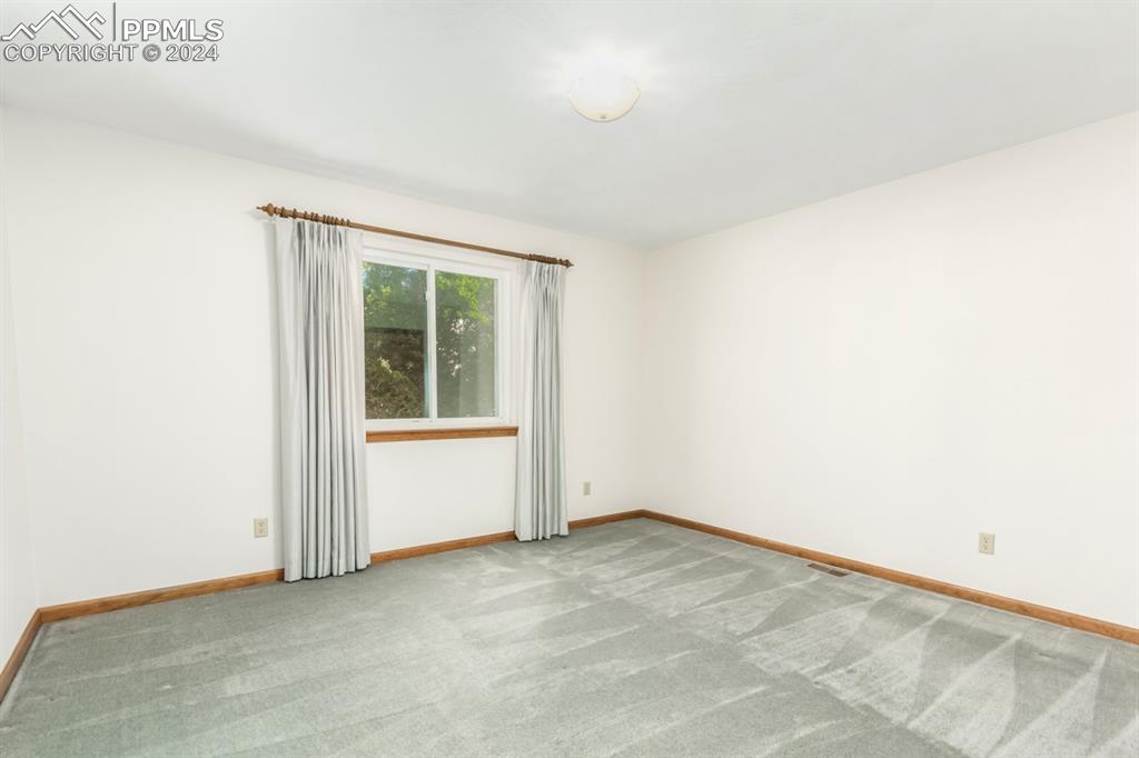 3955 Saddle Rock Road Colorado Springs, CO 80918 - Photo 30 of 45 a view of an empty room with a window