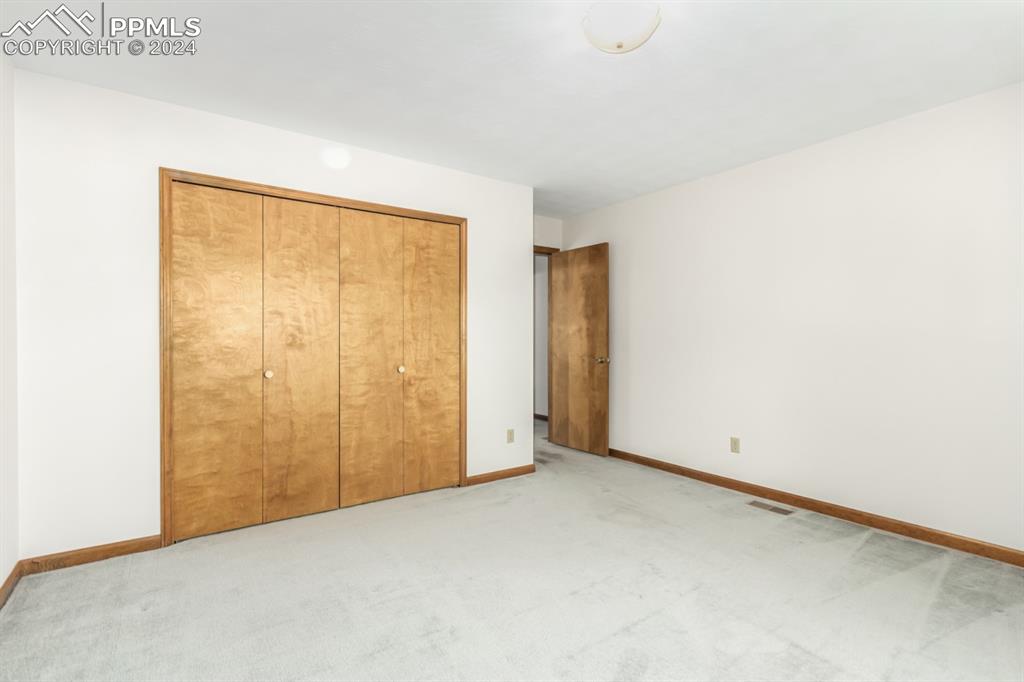 3955 Saddle Rock Road Colorado Springs, CO 80918 - Photo 31 of 45 a view of an empty room with a window