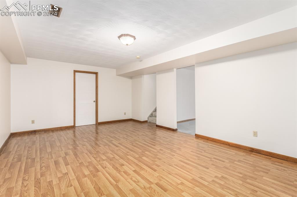3955 Saddle Rock Road Colorado Springs, CO 80918 - Photo 32 of 45 a view of an empty room with wooden floor