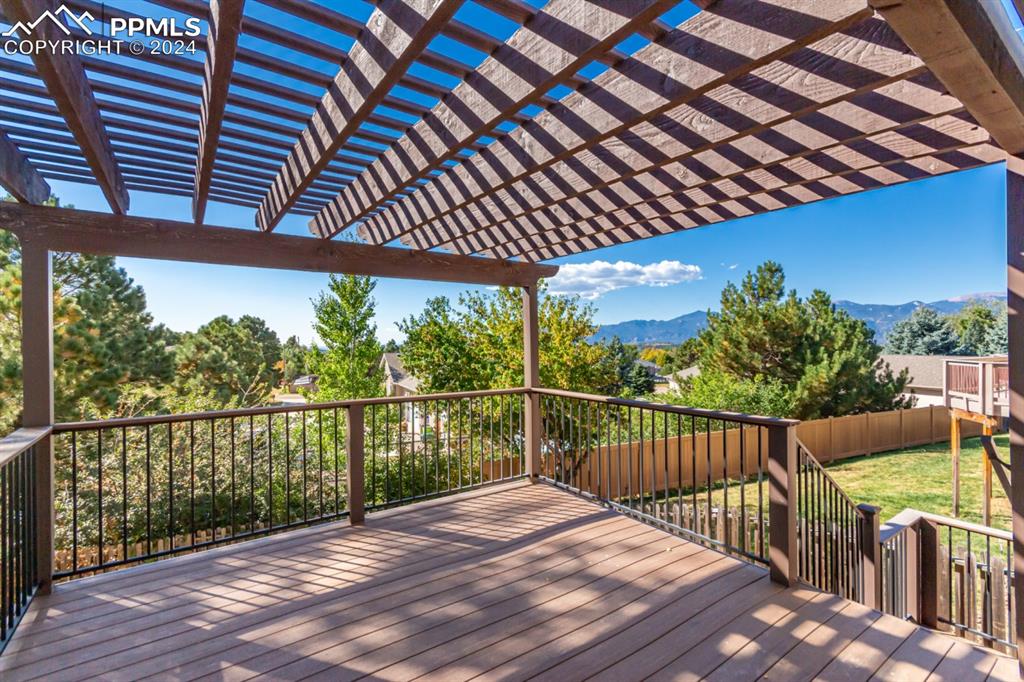 3955 Saddle Rock Road Colorado Springs, CO 80918 - Photo 41 of 45 a balcony with wooden floor and fence