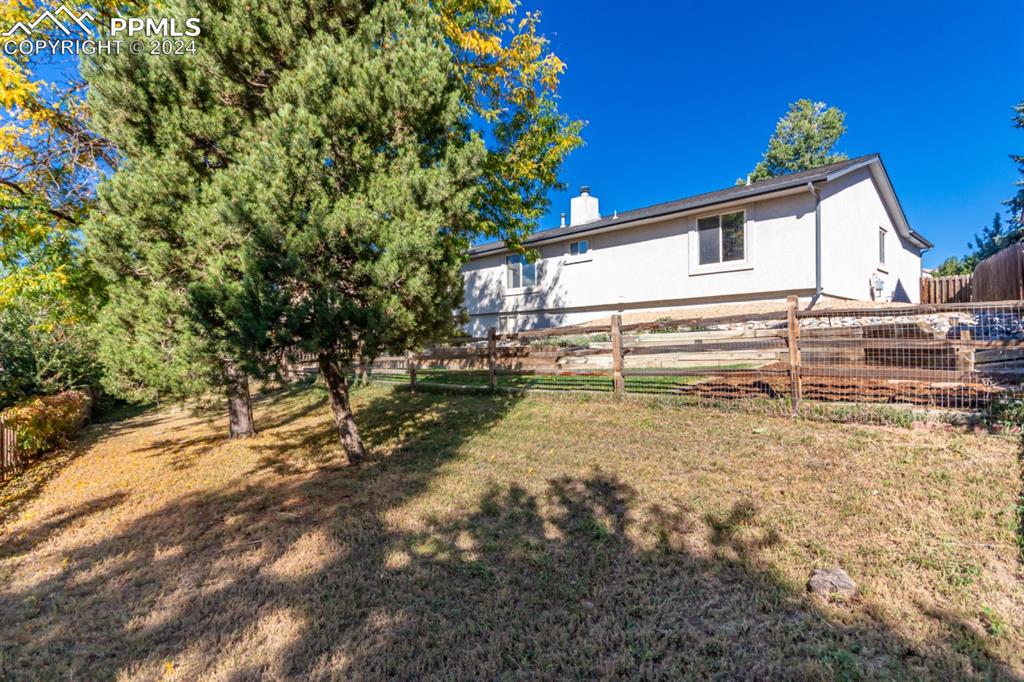 3955 Saddle Rock Road Colorado Springs, CO 80918 - Photo 44 of 45 a view of a house with a yard