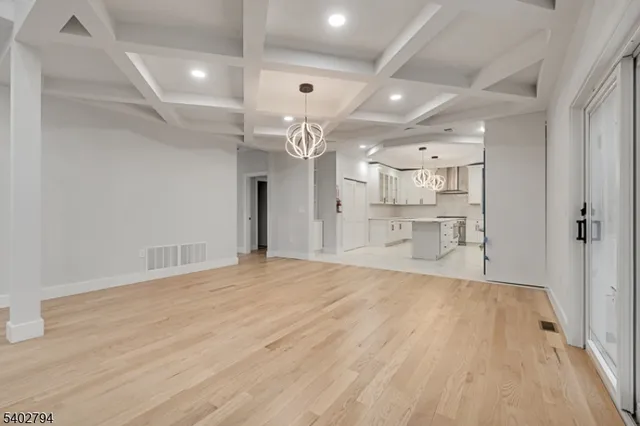a view of a kitchen with a sink and a refrigerator