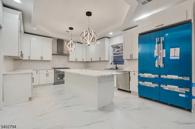 a large kitchen with cabinets and stainless steel appliances