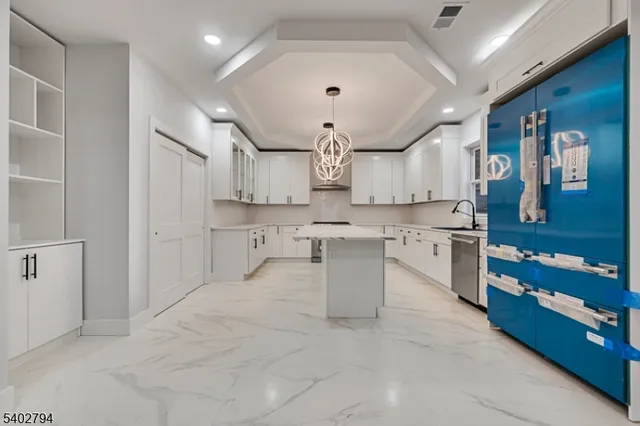 a large white kitchen with lots of counter space and appliances