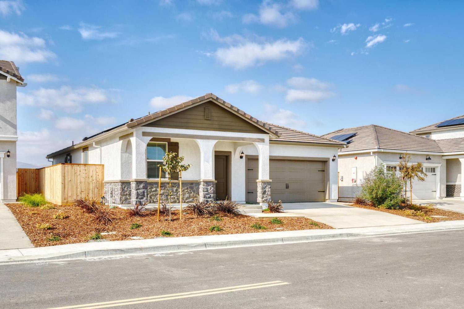 816 Chatham Lane Patterson, CA 95363 - Photo 2 of 15 a front view of a house with a garden