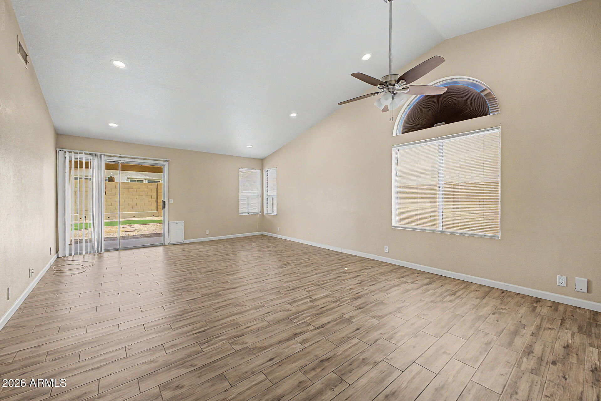 8564 West Ocotillo Road Glendale, AZ 85305 - Photo 9 of 34 an empty room with wooden floor and ceiling fan