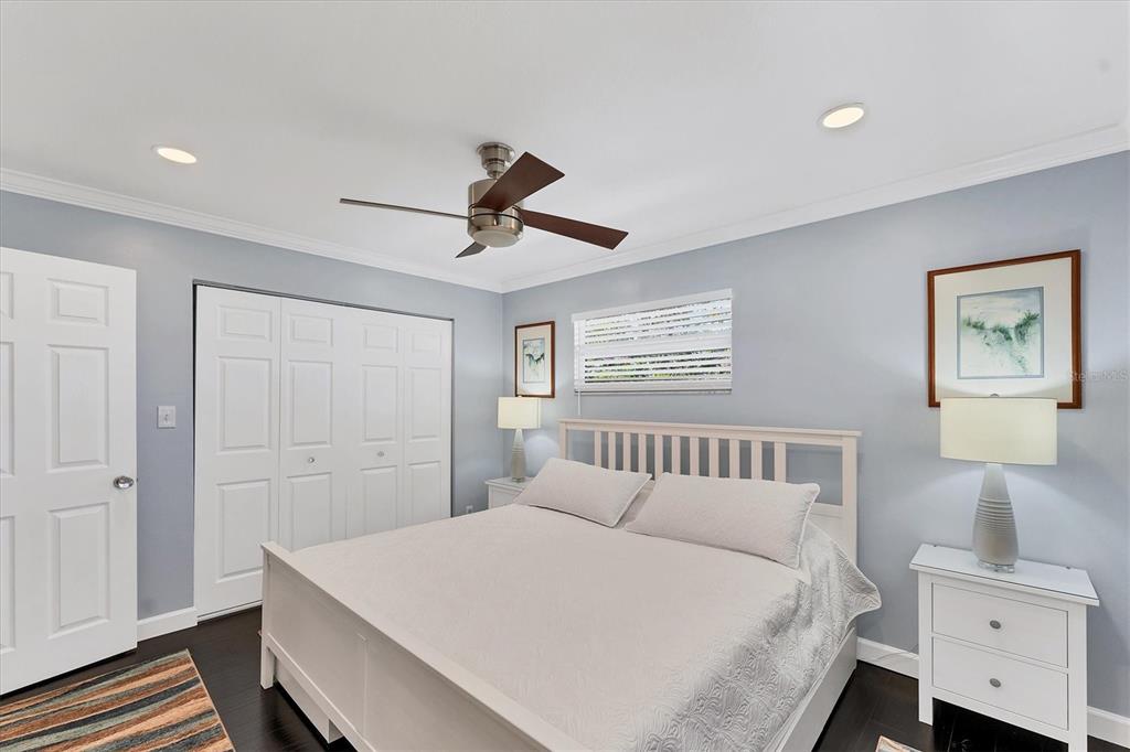 527 Sutton Place Longboat Key, FL 34228 - Photo 33 of 88 a bedroom with a large bed and a chandelier