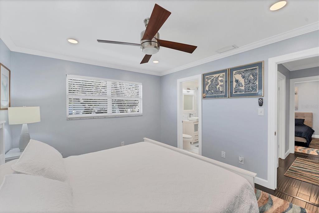 527 Sutton Place Longboat Key, FL 34228 - Photo 34 of 88 a bedroom with a large bed and a window