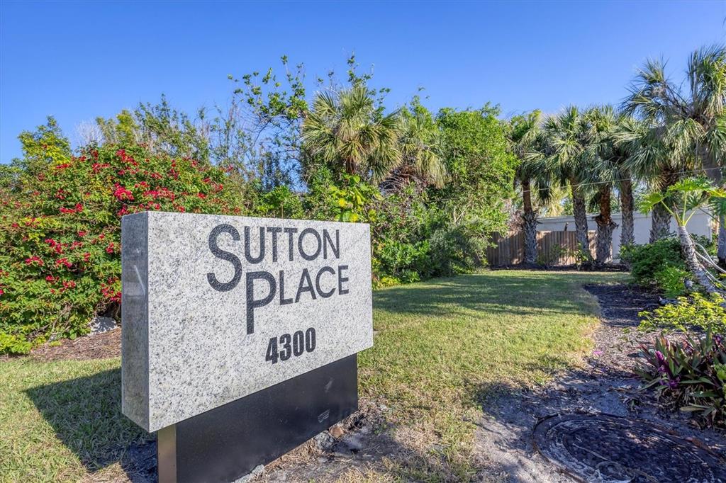 527 Sutton Place Longboat Key, FL 34228 - Photo 5 of 88 a sign on the side of the road