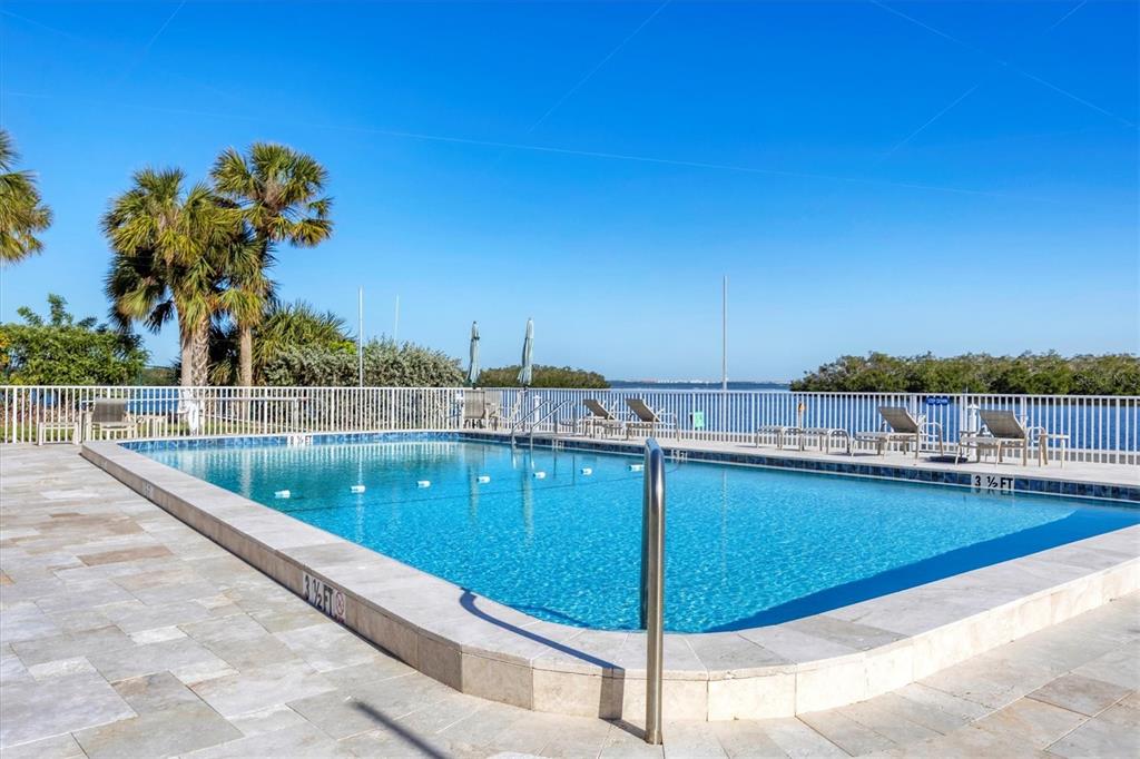 527 Sutton Place Longboat Key, FL 34228 - Photo 63 of 88 a view of a swimming pool with a lounge chairs