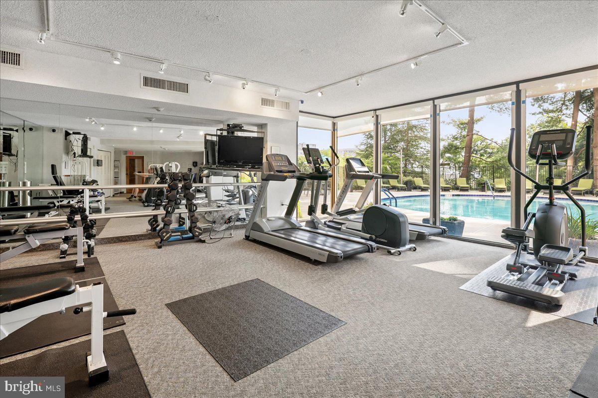 1101 South Arlington Ridge Road, Unit 402 Arlington, VA 22202 - Photo 51 of 61 Bright fitness oasis with pool views.
