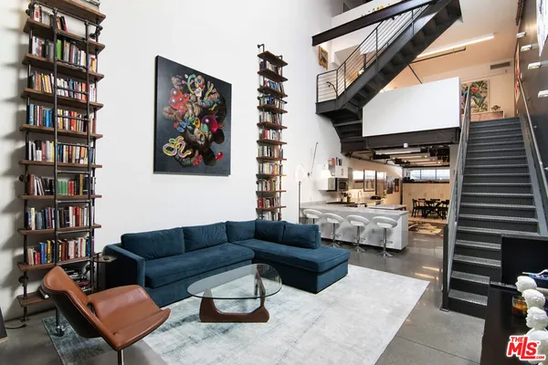 a living room with furniture and a book shelf