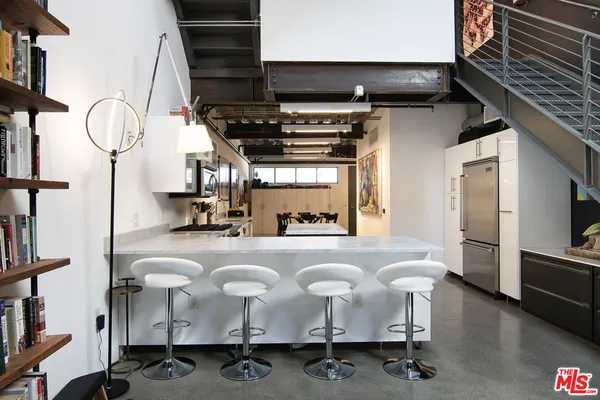 a kitchen with a stove a microwave and a dining table