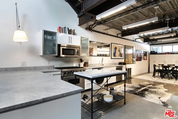 a kitchen with a sink cabinets and window