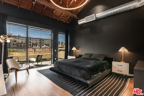 a spacious bedroom with a bed dresser and a window