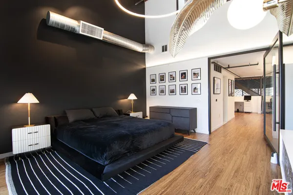 a bedroom with a bed a table and chair