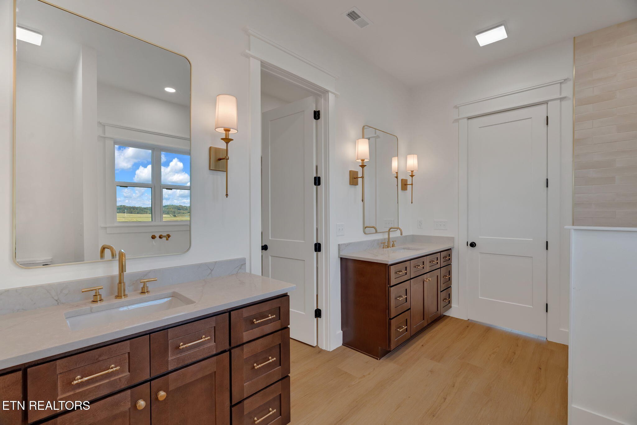 245 Pates Hill Road Mosheim, TN 37818 - Photo 15 of 35 a spacious bathroom with a granite countertop double vanity sink and a mirror