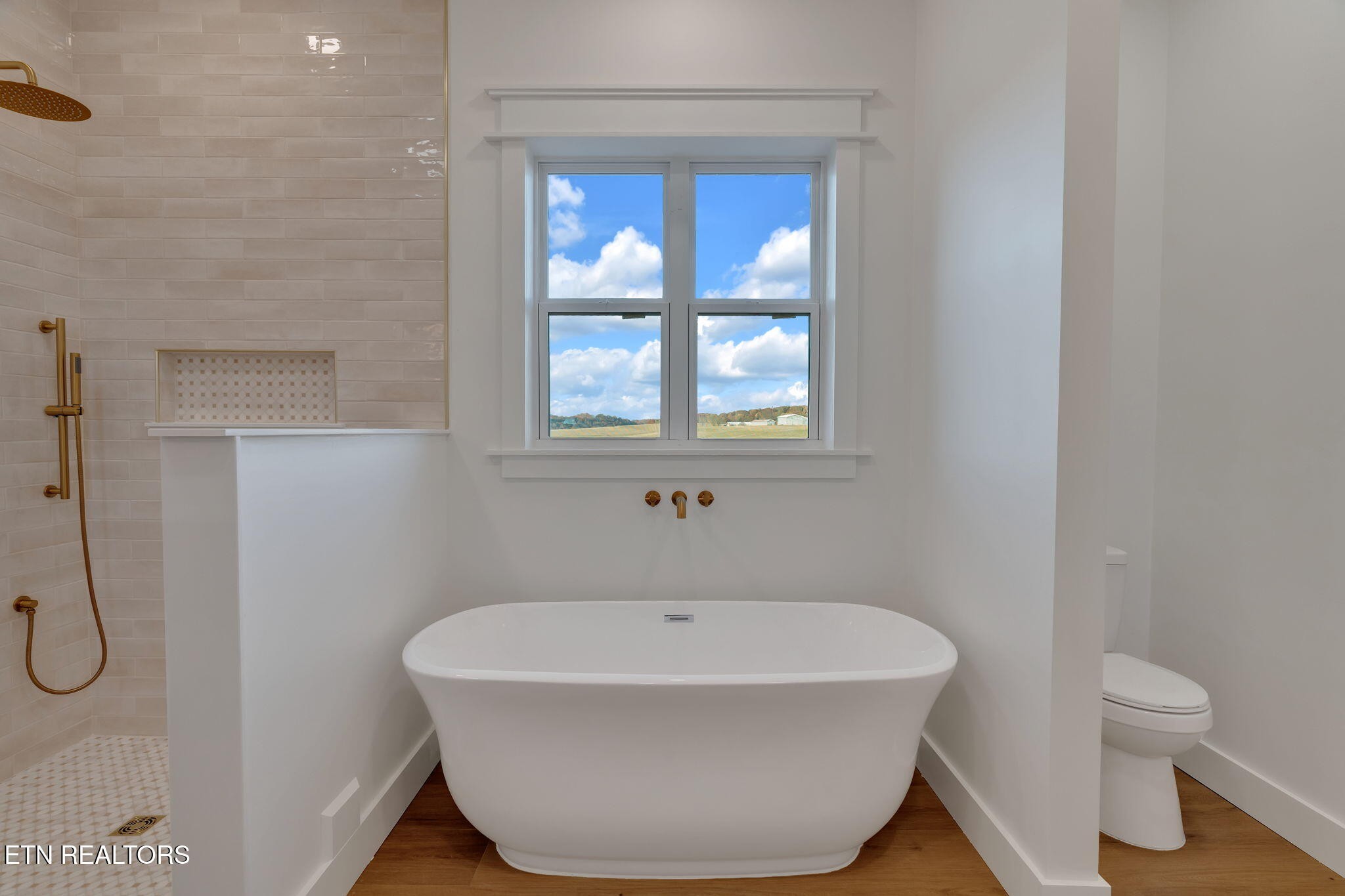 245 Pates Hill Road Mosheim, TN 37818 - Photo 16 of 35 a white bath tub sitting next to a toilet