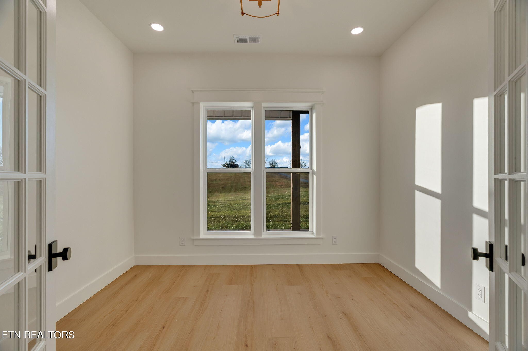 245 Pates Hill Road Mosheim, TN 37818 - Photo 19 of 35 an empty room with windows