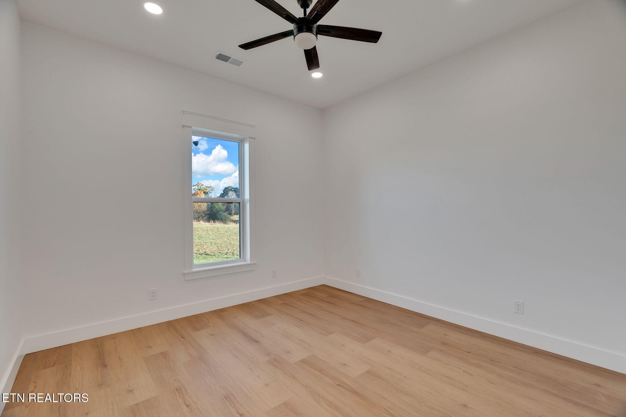 245 Pates Hill Road Mosheim, TN 37818 - Photo 23 of 35 an empty room with a window and a fan