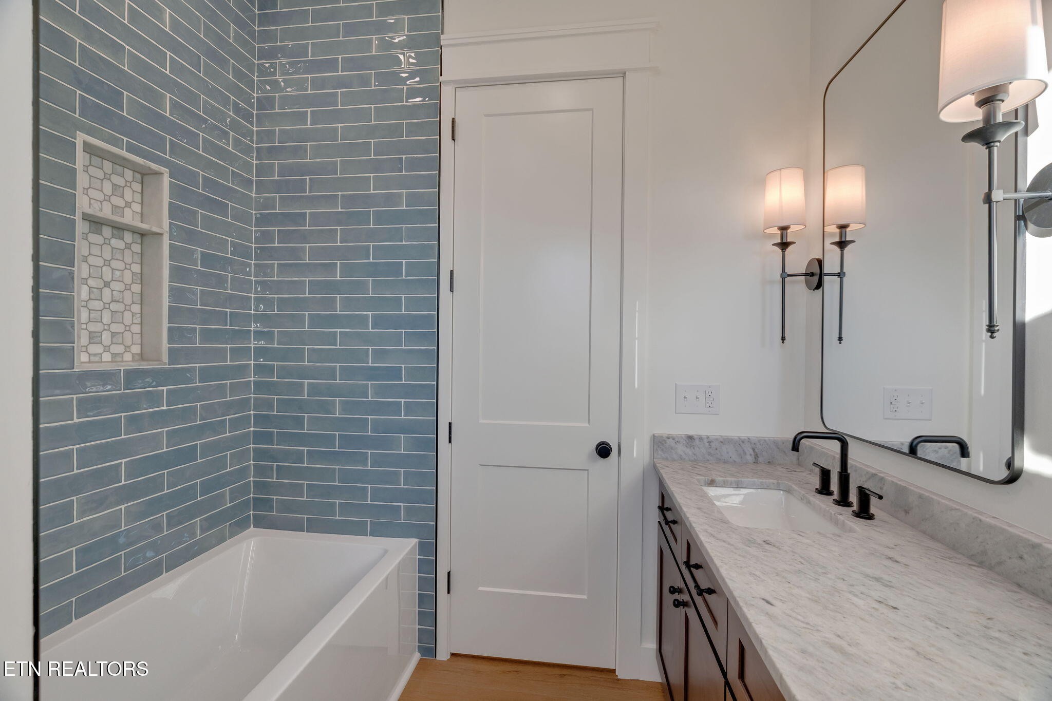 245 Pates Hill Road Mosheim, TN 37818 - Photo 25 of 35 a bathroom with a granite countertop sink a toilet and bathtub